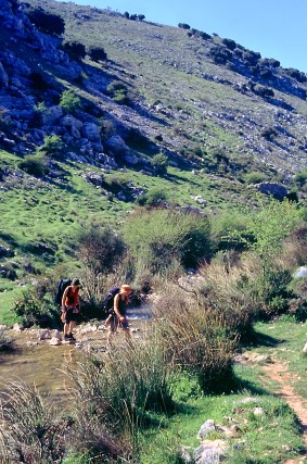 Foto von Wanderern, die den Río Bailón (Sierras Subbéticas, Andalusien) überqueren
